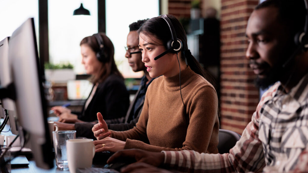 Support and maintenance featured image showing support workers responding to customer queries via telephone