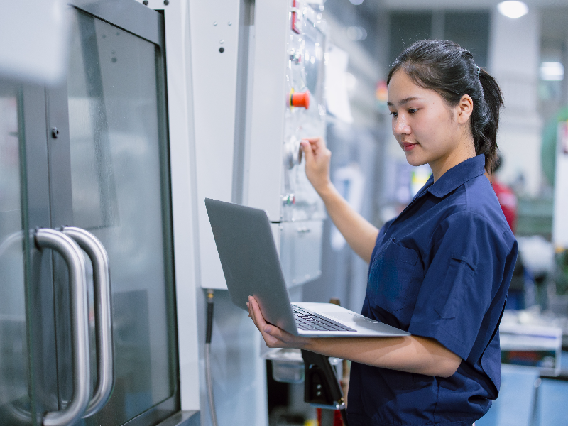 Worker on a computer in a manufacturing facility