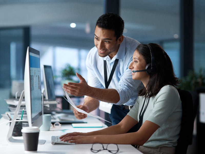 IT support staff around a computer