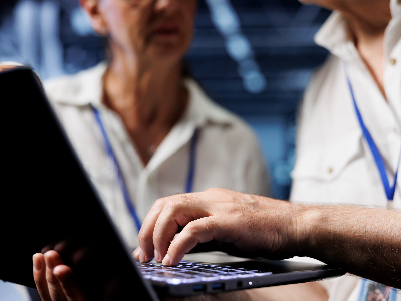 Staff holding a laptop