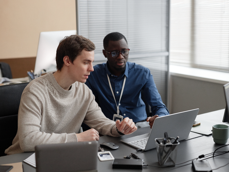 Two IT staff at a computer