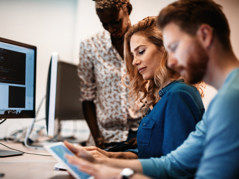 IT workers at a computer working on a task