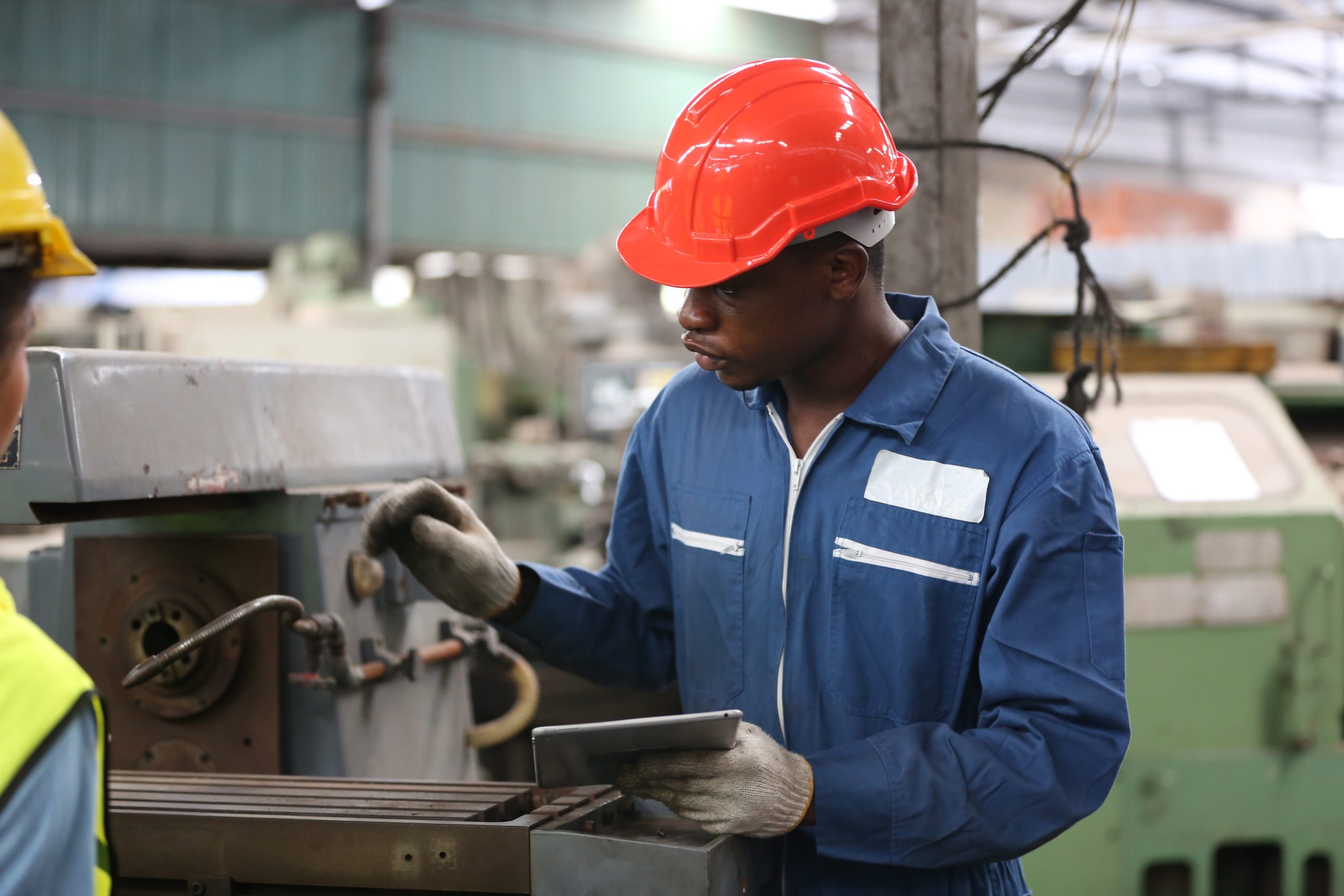 Man working via production scheduling on his iPad